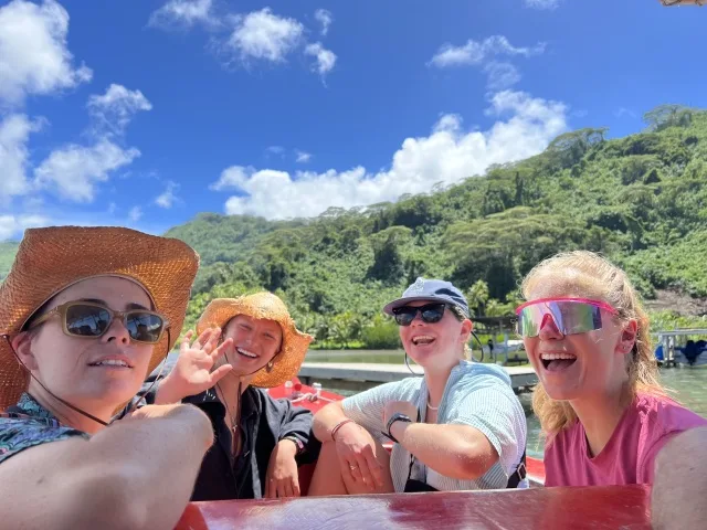 Kelly, Stella, Orly, and Lexi (left to right) on the out rigger style boat on the tour of Raiatea