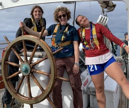 Carly, Stevie, and Audrey at the helm of the SSV Robert C. Seamans.