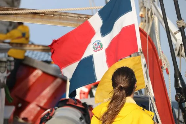 Claire raising the Dominican flag as we enter Samana Bay.