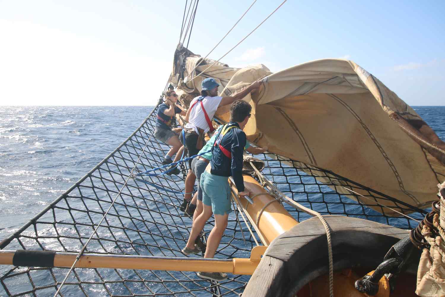 A Watch furling the JT out on the bowsprit during the day