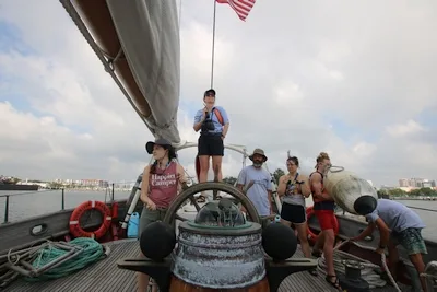 As we leave the dock, Kayla handles the helm, Kira prepares to go on watch, and Alex mans a fender while Captain Allison and the crew work to maneuver us safely out.