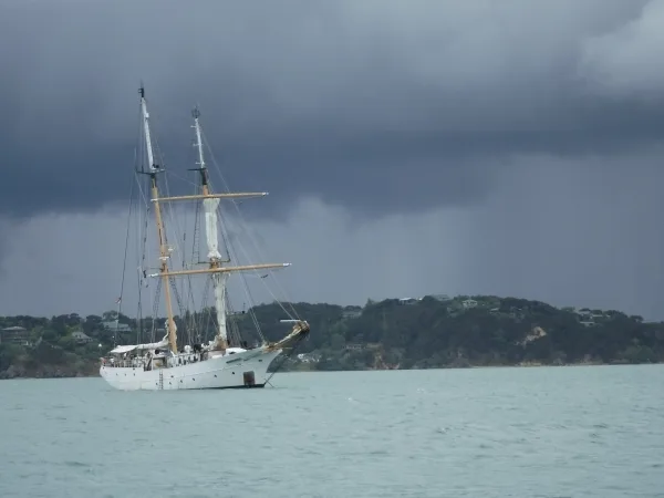 The Robert C. Seamans at anchor in Kororareka Bay, with Pahia in the background