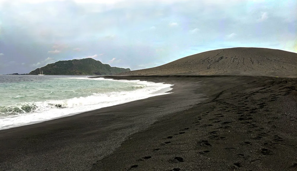 The newly erupted cone (right), and pre-existing Hunga Tonga (to left), with SSV Robert C. Seamans