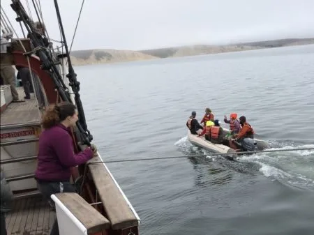 C-watch motoring to shore in the small boat.