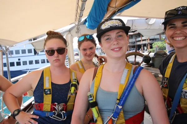 Students Lila, Una and Rosie strike a pose in their new safety harnesses, along with Dr. Mikki.