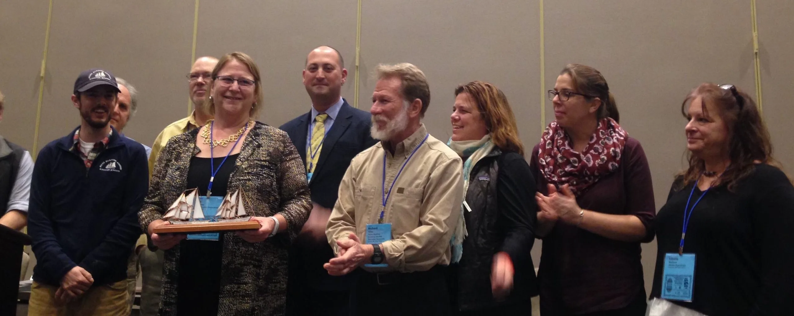 SEA staff|Jen Haddock accepts award from Jonathan Kabak.