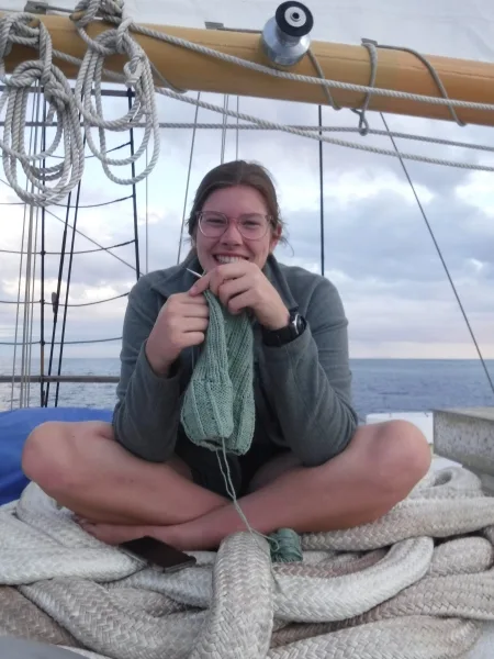 The author, Lilli Dwyer, from University of Rhode Island, sitting on the house top at sea on the Hauraki Gulf, Aoteaora, New Zealand.