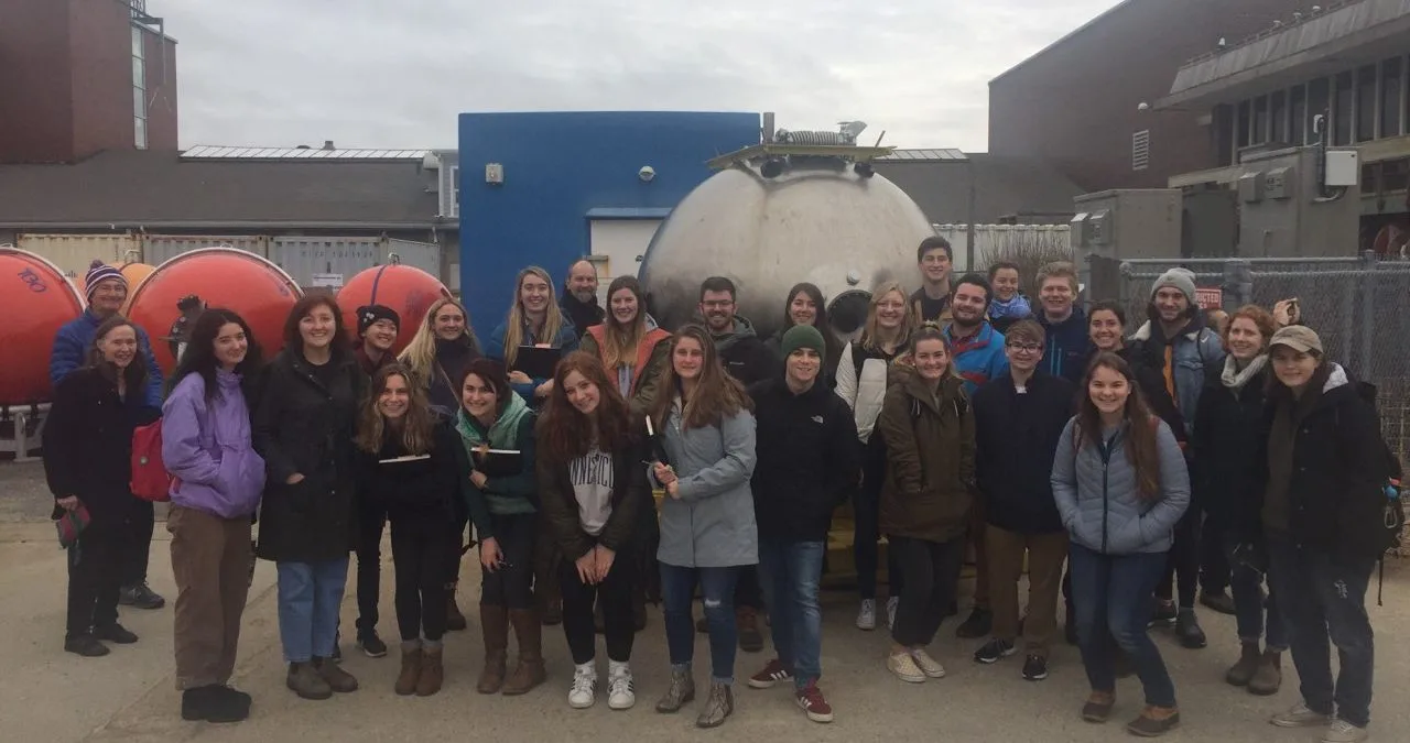 Global Ocean S-290 students on a tour of Woods Hole, standing in front of the old cockpit of the submersible Alvin;